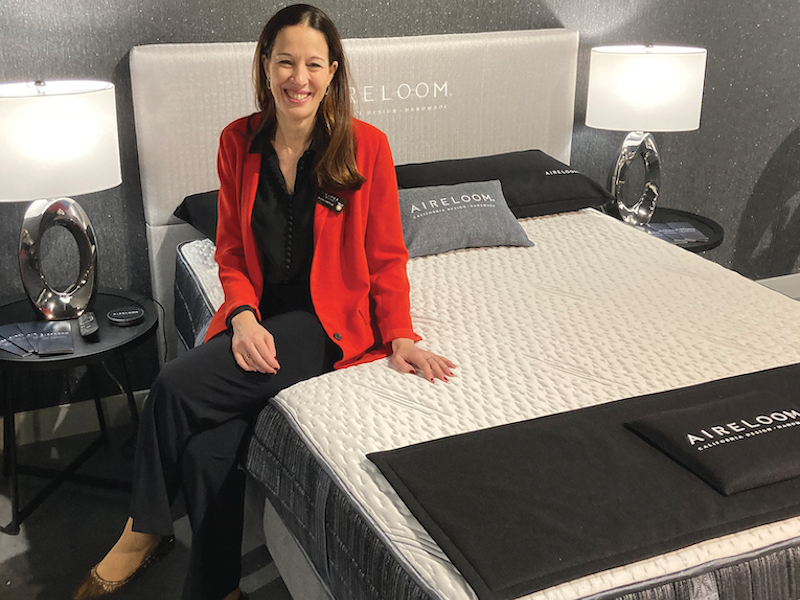 Legacy of Quality. Magali Castillo, vice president of marketing for E.S. Kluft & Co., perches atop a luxury memory foam mattress, part of The Pinnacle Collection.