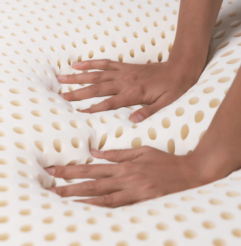 latex manufacturing innovation. A consumer experiences the unique feel of Talalay Global latex which is both soft and pressure-relieving.